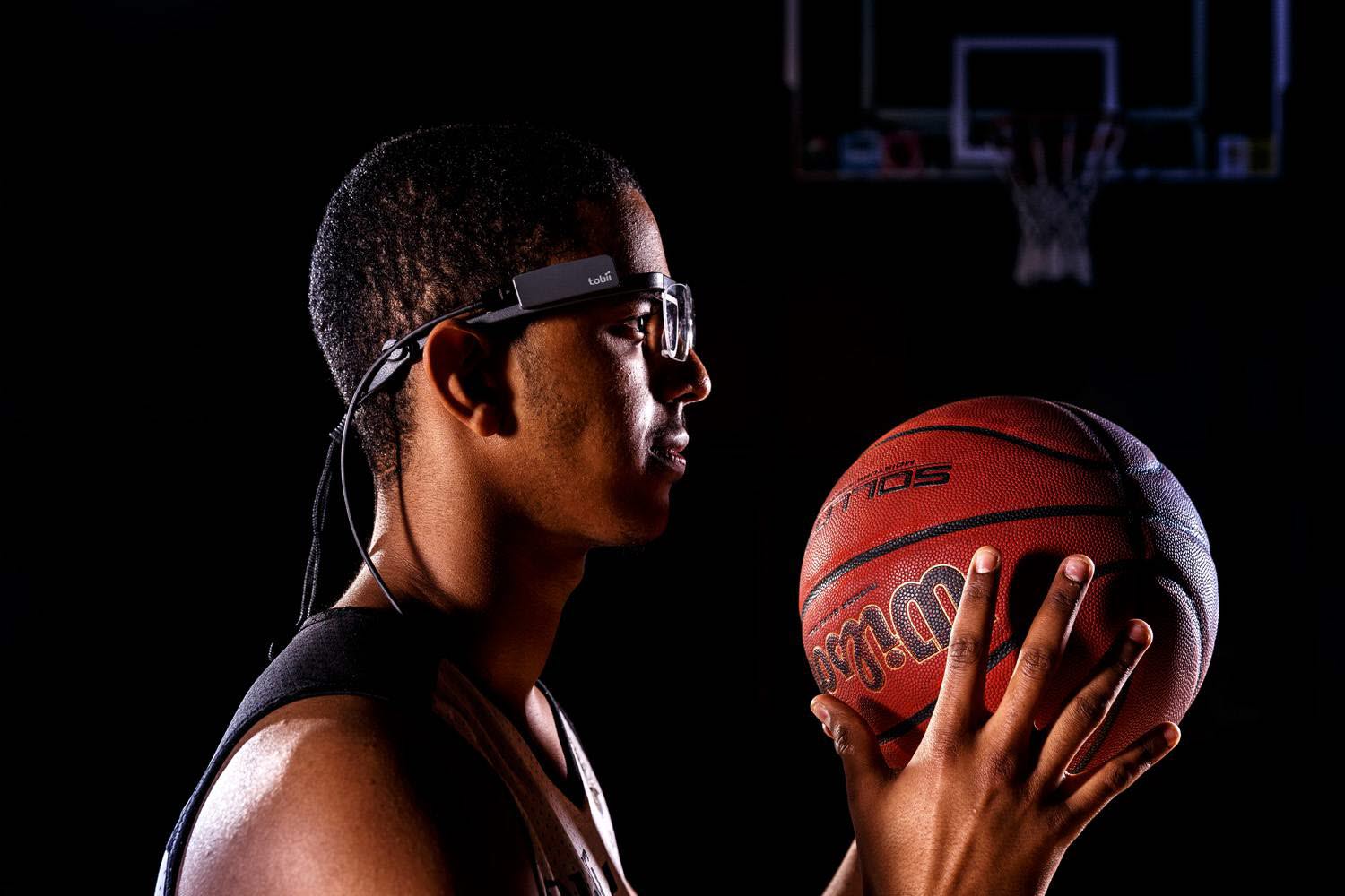A closeup of a basketball player wearing Tobii Pro Glasses 2 eye tracker
